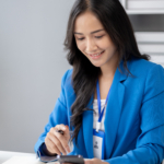 Beautiful asian woman looking at data on phone, businesswoman wo