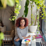 Entrepreneur owning her design company sitting near window