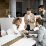 Group of young business people making a deal at a meeting in the